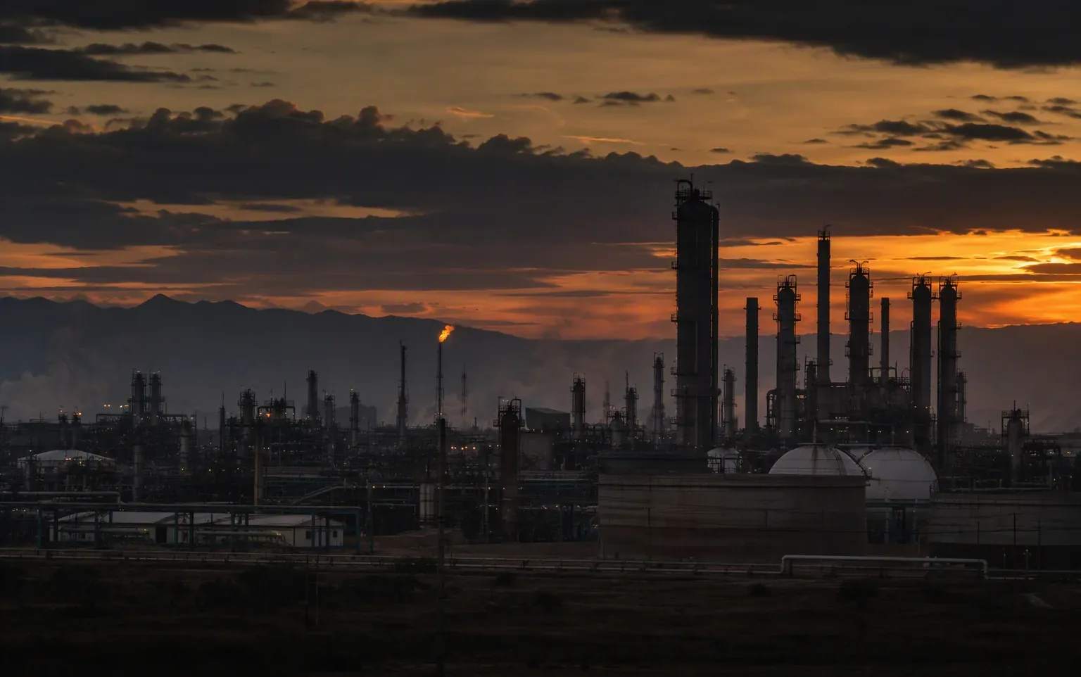 Illustrative view of an industrial refinery complex at dusk